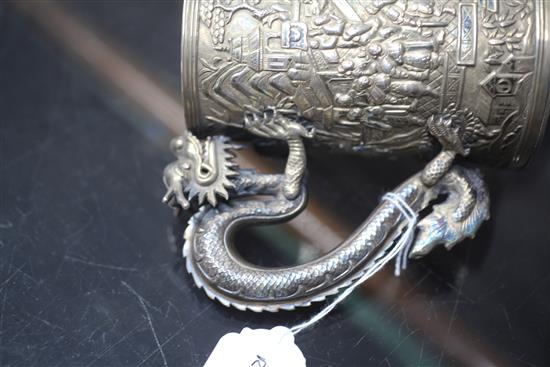 A mid-19th century Chinese silver mug, the body featuring warriors fighting to one side, with inscribed shield plaque H.13cm.